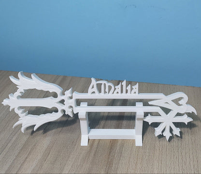 White decorative item with 'Amalia' branding on a wooden surface and blue background