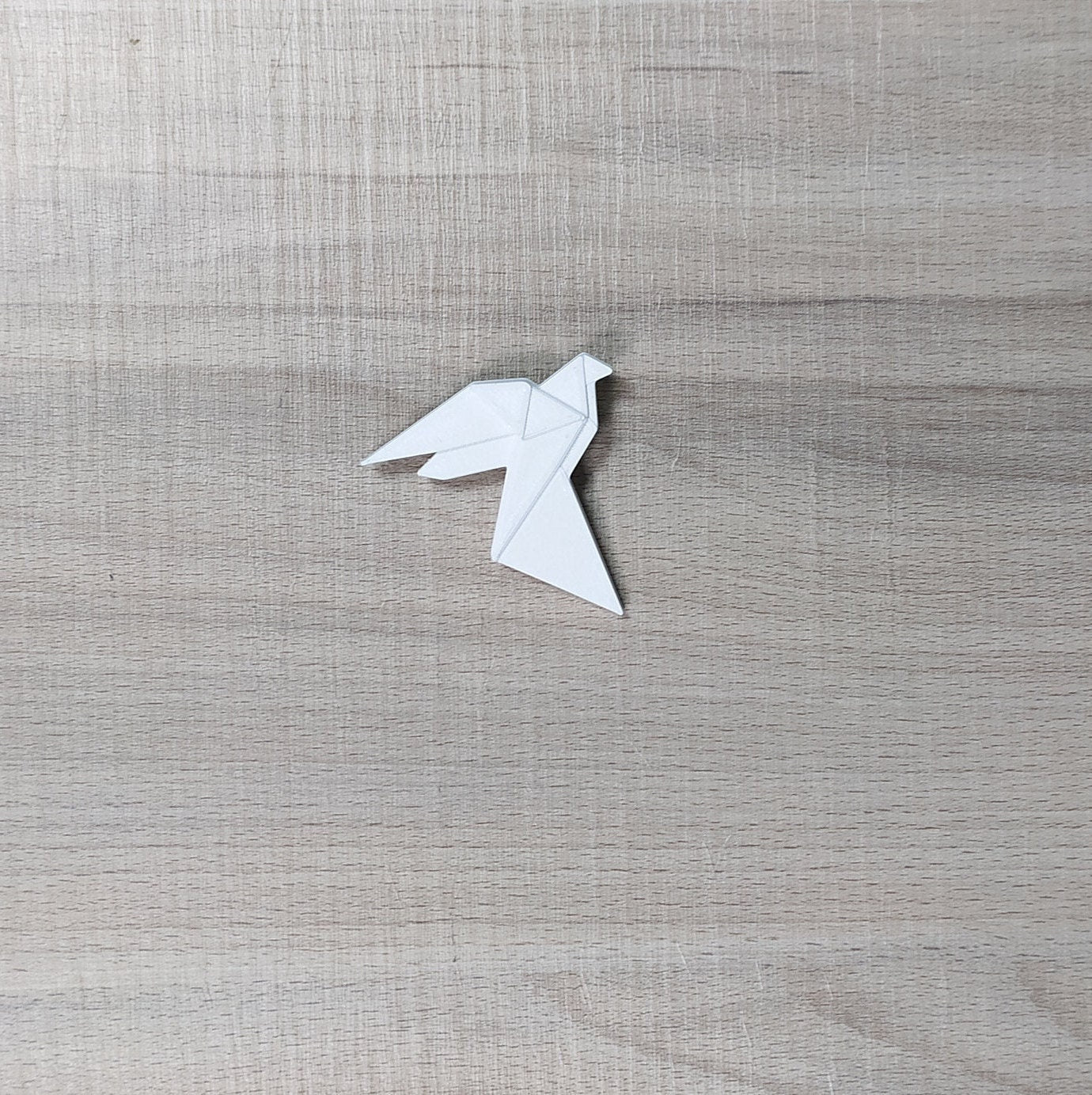 White origami dove on a textured gray background